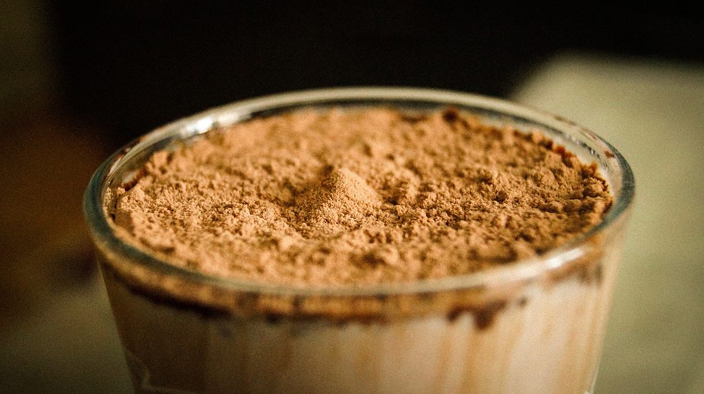 Close-up of a glass filled with chocolate milk powder