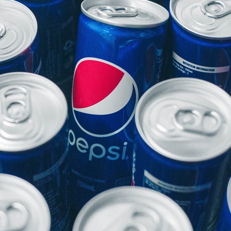Multiple Pepsi cans arranged closely