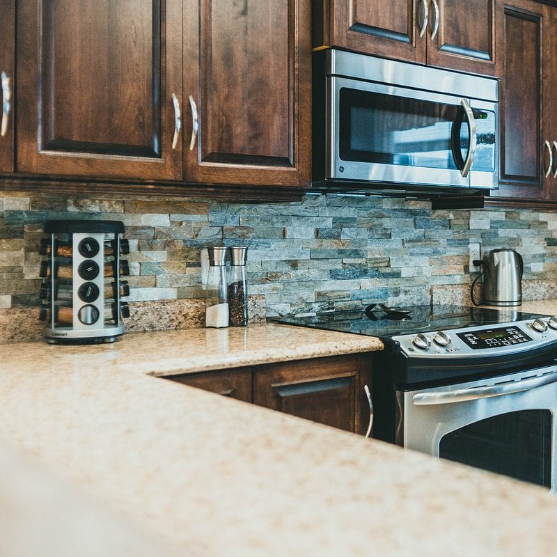 Modern kitchen with stainless steel appliances and cherry wood cabinets