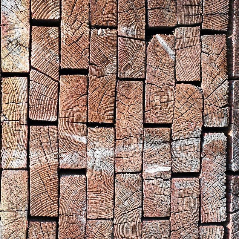 Stacked wooden logs cross-section texture and patterns