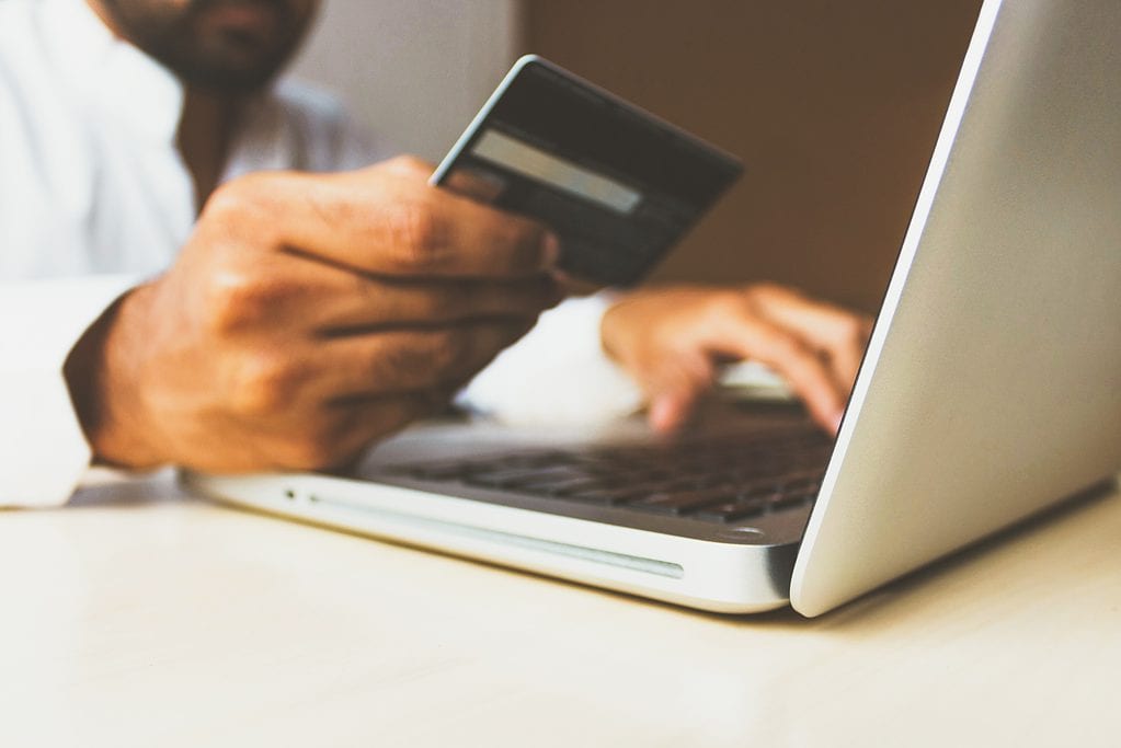 Man using credit card for online payment on laptop