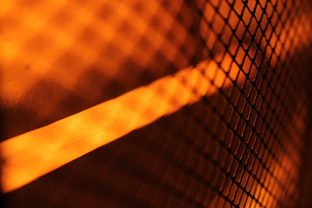 Warm glowing light filtered through a metal grid pattern