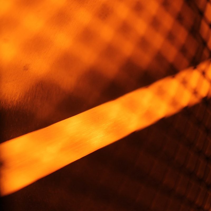 Warm glowing light filtered through a metal grid pattern