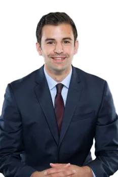 Professional man in business suit smiling against white background