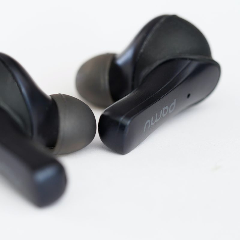Black wireless earbuds on white background