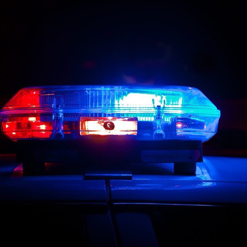 Illuminated red and blue police car lights at night