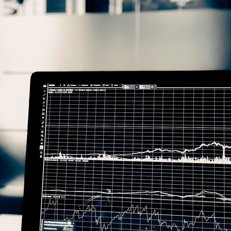 Close-up of a computer screen displaying financial stock market graphs.