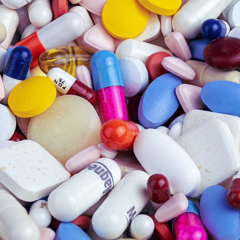 Close-up of assorted pharmaceutical pills and capsules in various colors and shapes.