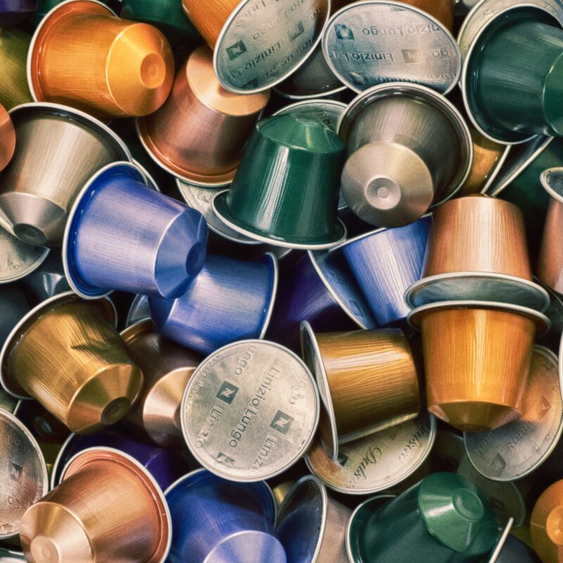 Assorted used coffee capsules piled together